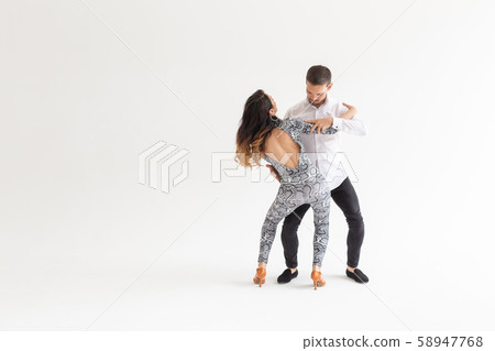 Young couple dancing latin dance bachata, merengue, salsa, kizomba. Two elegance pose over white 58947768