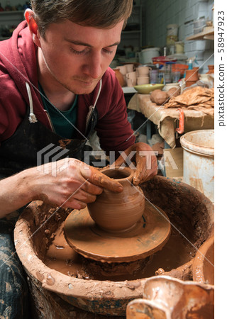 Potter at work. Workshop. 58947923