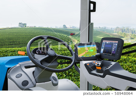 Autonomous tractor working in green tea field Autonomous tractor working in green tea field 58948064