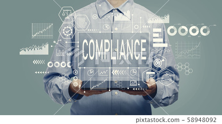Compliance concept with man holding a tablet 58948092