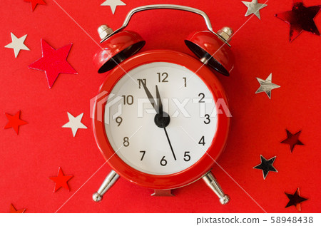 Festive Christmas background with alarm clock on red background in minimal style. Festive Christmas background with alarm clock on red background in minimal style. 58948438