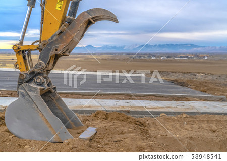 Excavator bucket with view of mountain and sky 58948541