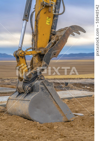 Excavator bucket with mountain and sky background Excavator bucket with mountain and sky background 58948542