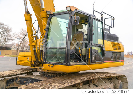 Empty cab of an excavator with soil on grouser pad Empty cab of an excavator with soil on grouser pad 58948555
