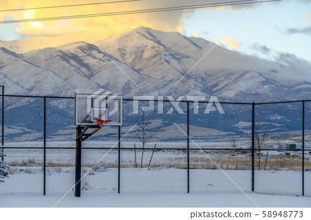 Basketball court and mountain covered with snow 58948773