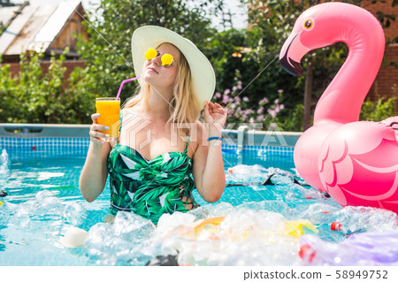 Problem of trash, plastic recycling, pollution and environmental concept - silly woman swims and 58949752