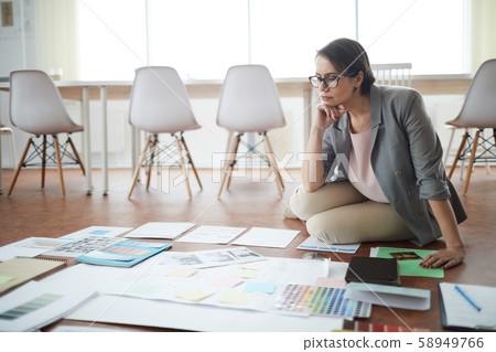 Pensive Businesswoman Sitting on Floor 58949766