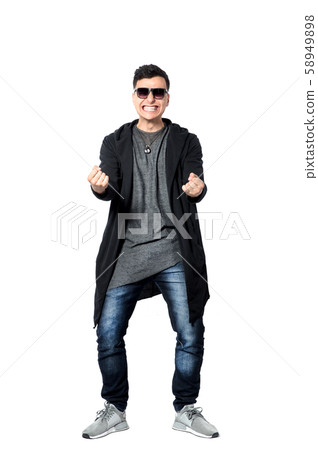 Casual young man wearing sunglasses, hands up, happy, positive a 58949898