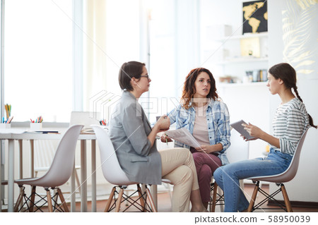 Modern Young Women Discussing Business Modern Young Women Discussing Business 58950039