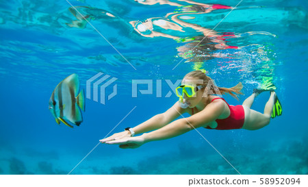 Young woman in snorkeling mask dive underwater Young woman in snorkeling mask dive underwater 58952094
