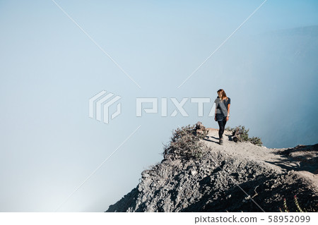 Woman in protective mask on active volcano Kawah Woman in protective mask on active volcano Kawah 58952099