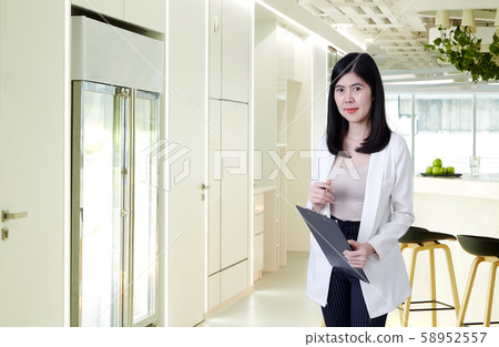 asian businesswoman holding documents in the asian businesswoman holding documents in the 58952557