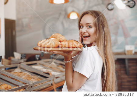 Beautiful girl buys buns at the bakery Beautiful girl buys buns at the bakery 58953317