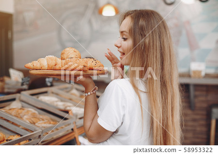Beautiful girl buys buns at the bakery Beautiful girl buys buns at the bakery 58953322