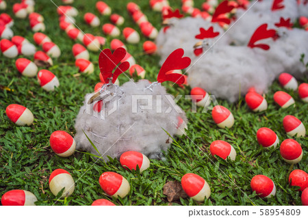 Chicken and red eggs on the lawn 58954809