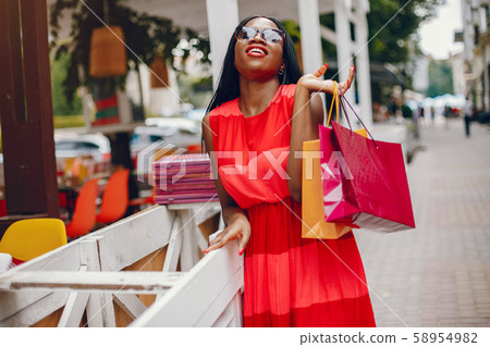 Beautiful black girl with shopping bags in a city 58954982