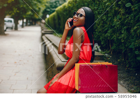 Beautiful black girl with shopping bags in a city 58955046