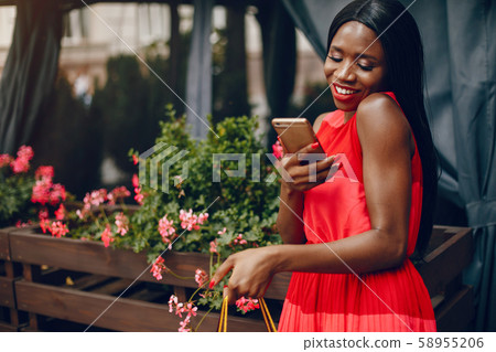 Beautiful black girl with shopping bags in a city Beautiful black girl with shopping bags in a city 58955206