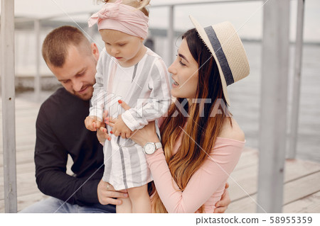 Family with daughter playing in a park 58955359