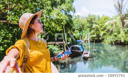 Asian couple holding hands, traveling nature. Travel relax. at tha pom-klong-song-nam. Krabi, in Thailand. Travel Thailand. Honeymoon, romantic. Asian couple holding hands, traveling nature. Travel relax. at tha pom-klong-song-nam. Krabi, in Thailand. Travel Thailand. Honeymoon, romantic. 58955741