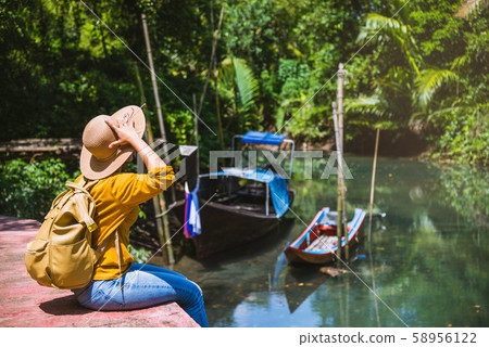 Asian woman travel nature. Travel relax.a boat photo. Sitting watching the beautiful nature 58956122