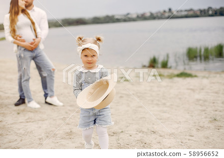 Family with daughter playing in a park Family with daughter playing in a park 58956652
