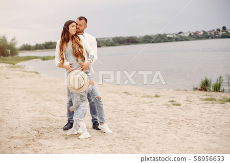 Family with daughter playing in a park Family with daughter playing in a park 58956653
