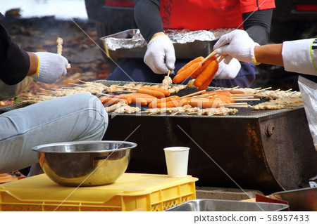 Image of grilling sausages and meat at a local event 58957433