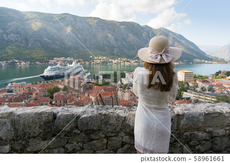 A girl looks from the heights to the Boka Bay of Kotor 58961661