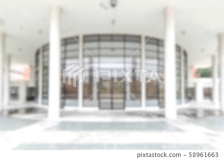 Blur office background building exterior view to lobby glass window wall with blurry light bokeh Blur office background building exterior view to lobby glass window wall with blurry light bokeh 58961663