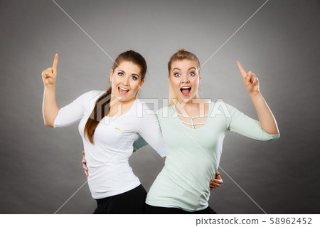 Happy women pointing up with one finger. Happy women pointing up with one finger. 58962452