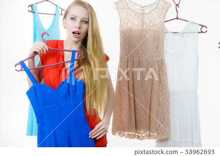 Woman choosing clothes in shop Woman choosing clothes in shop 58962693