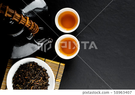 Hot tea in glass teapot and cup with steam 58963407