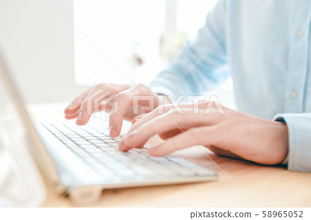 Hands of young analyst or designer typing by table in front of computer 58965052