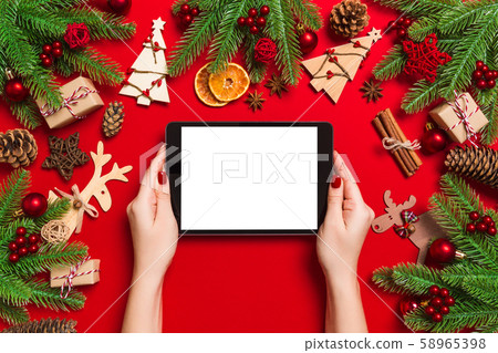 Top view of woman holding tablet in her hands on Top view of woman holding tablet in her hands on 58965398
