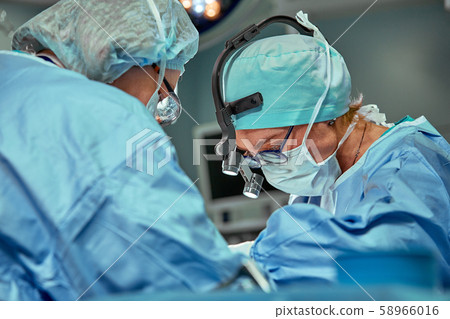 Portrait of a team of surgeons at work. During surgery. Concept medicine, saving lives. Portrait of a team of surgeons at work. During surgery. Concept medicine, saving lives. 58966016