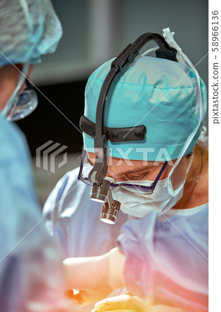 Portrait of a team of surgeons at work. During surgery. Concept medicine, saving lives. Portrait of a team of surgeons at work. During surgery. Concept medicine, saving lives. 58966136
