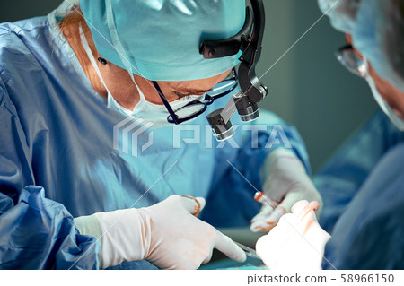 Portrait of a team of surgeons at work. During surgery. Concept medicine, saving lives. Portrait of a team of surgeons at work. During surgery. Concept medicine, saving lives. 58966150