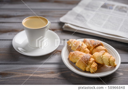 Coffee and homemade cookies bagels on wooden background. Near a newspaper 58966848