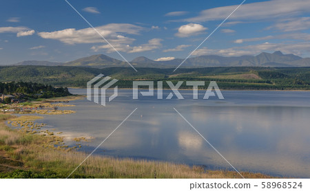Mountains reflected in a calm lake Mountains reflected in a calm lake 58968524