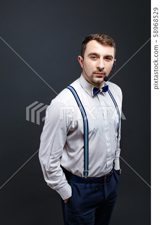 Portrait of stylish man in suspenders and bow-tie 58968529