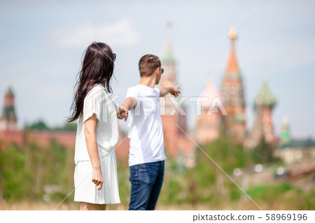 Young dating couple in love walking in city background St Basils Church 58969196