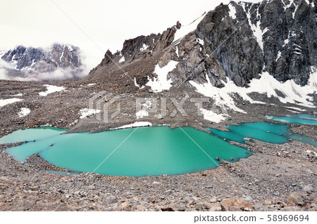 The Gauri Kund mountain lake around mount Kailash The Gauri Kund mountain lake around mount Kailash 58969694