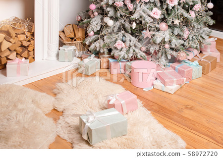 Beautiful Christmas gift boxes on floor near fir Beautiful Christmas gift boxes on floor near fir 58972720