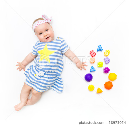 Portrait of a sweet infant baby girl wearing a pink dress and headband bow, isolated on white in Portrait of a sweet infant baby girl wearing a pink dress and headband bow, isolated on white in 58973054
