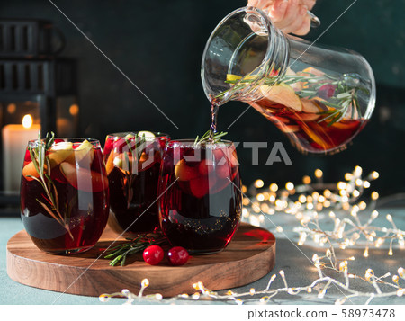 Winter sangria pouring in glasses, christmas table 58973478