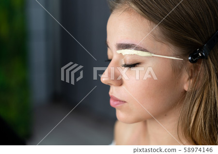 Young beautician caucasian girl holds model Young beautician caucasian girl holds model 58974146