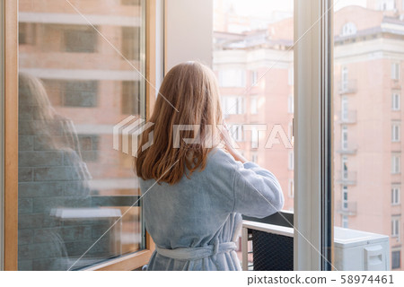 Blonde woman in bathrobe drinking her morning 58974461