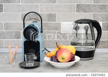 Coffee machine and electric kettle in the kitchen. Coffee machine and electric kettle in the kitchen. 58974462