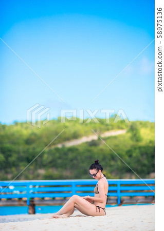 Young fashion woman in swimsuit on the beach 58975136